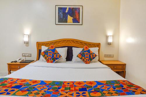 a bedroom with a bed with a colorful comforter at FabHotel Prime Ambassador in Pune