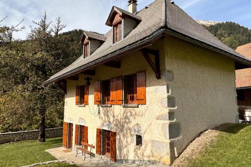 a building with windows and a black roof at Le Nid de Pajonnière en chartreuse in Saint-Pierre-de-Chartreuse