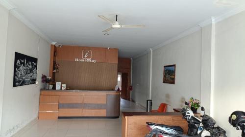 a living room with a kitchen with a ceiling fan at IHomestay Pekanbaru in Pekanbaru