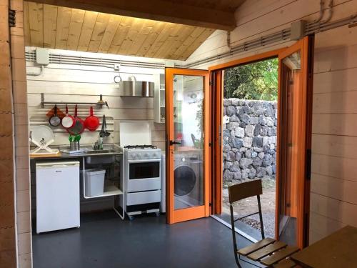 a kitchen with a stove and a sink at Miniglamp E.V. - Camping in Ischia