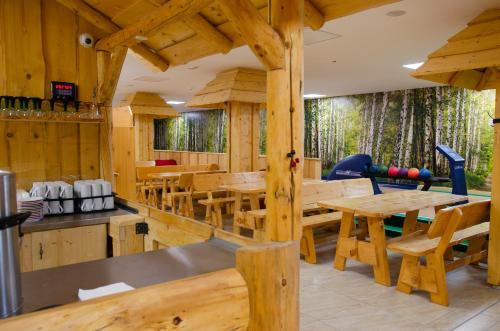 a dining room with wooden tables and chairs at Chata Emil Zatopek - Maraton - Lysa Hora in Krásná