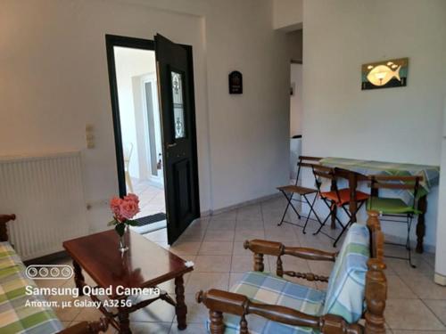 a living room with a table and chairs and a door at Great stay & beautiful trails in Raches
