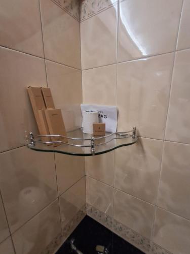 a shelf on a tiled wall with boxes on it at Presidency Towers,Kochi in Cochin