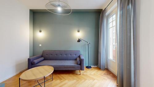 a living room with a couch and a table at Beautiful modern apartment with balcony in Geneva in Geneva