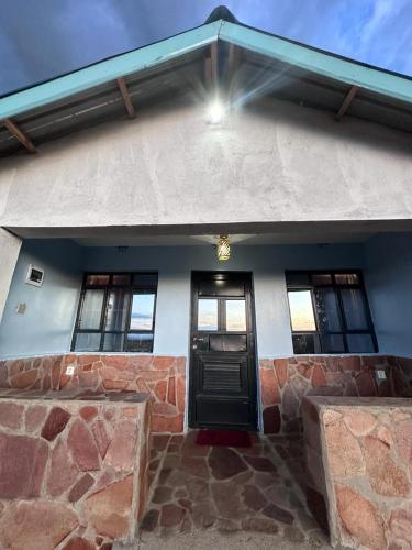 a house with a black door and some windows at Luluka Guest House in Sekenani
