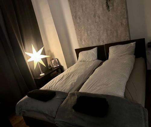 a bedroom with two beds and a star on the wall at Benvenuto Apartman in Budapest