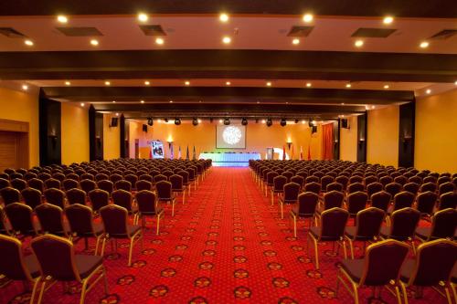 an empty hall with rows of chairs and a stage at Palm Plaza Marrakech in Marrakech