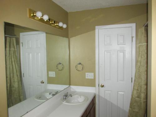 a bathroom with two sinks and a large mirror at Home With View of Columbia Cityscape in Sharpes Hill