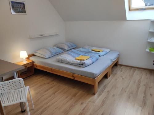 a bed with blue pillows on it in a room at Górski Kryształ in Stronie Śląskie