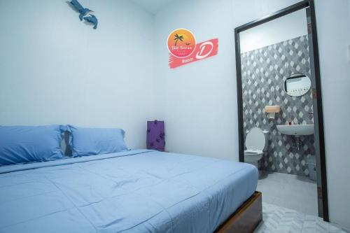 a bedroom with a bed and a mirror and a sink at Tamtawan Guesthouse Lipe - ตามตะวันเกสเฮ้าส์ หลีเป๊ะ in Ko Lipe