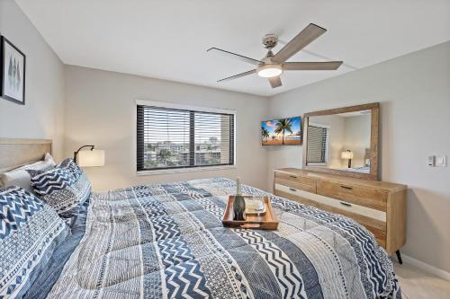 a bedroom with a bed and a ceiling fan at Seawinds 706 in Marco Island
