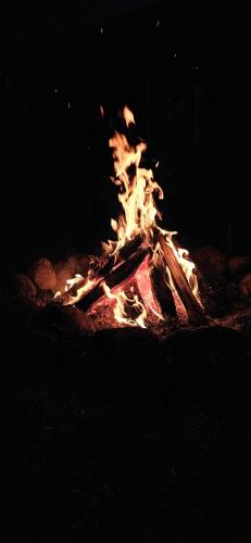 a fire is burning in a fire pit at night at Filipówka in Sztabin