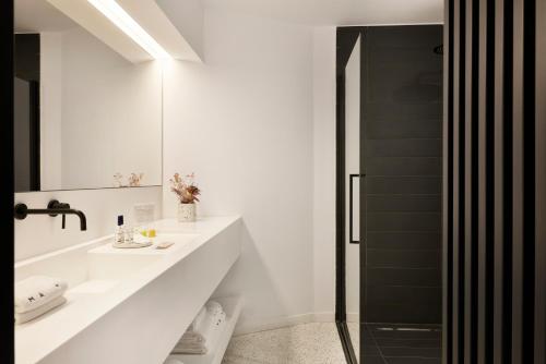 a white bathroom with a sink and a shower at MAP Boutique Hotel in Nicosia