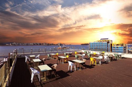 a group of tables and chairs on the deck of a ship at Hotel The Sea Star in Incheon