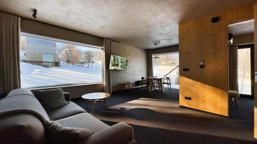 a living room with a couch and a large window at Wilcza For Rest in Karpacz
