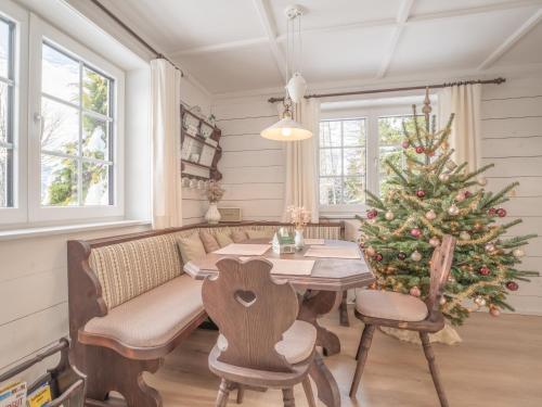 a dining room with a table and a christmas tree at Strickerl in Bad Goisern