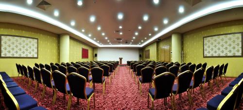 a room with rows of chairs in a building at Demosan Hotel in Karaman