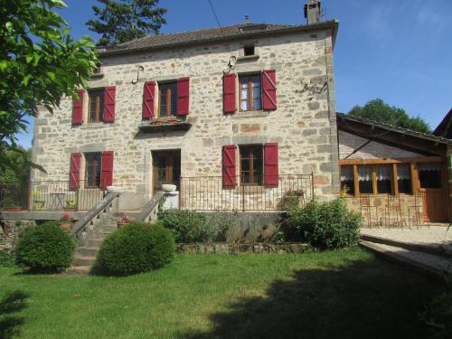 an old stone house with red shuttered windows at Ecuries de Saint Maurice- Maison d'hôtes de Gondou in Lacapelle-Marival