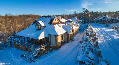 an aerial view of a house covered in snow at Villa Collis - Bieszczady in Olchowiec
