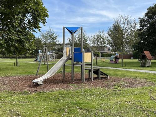 a playground with a slide in a park at Schorrebloem 31 in Nieuwvliet