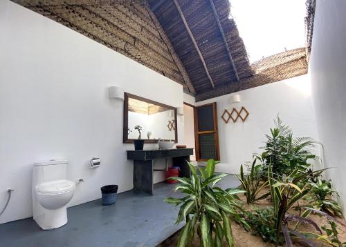 a bathroom with a toilet and a sink at The Coast Beach Resort in Agonda