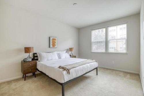 a white bedroom with a bed and a window at Santa Clara 2br w pool balcony elevator gym SFO-1587 in Santa Clara