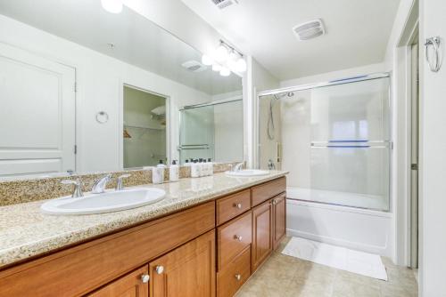a bathroom with two sinks and a shower at Santa Clara 2br w pool balcony elevator gym SFO-1587 in Santa Clara