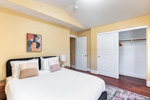 a bedroom with a large white bed and white doors at Milpitas 4br w garage nr mall dining SFO-1593 in Milpitas