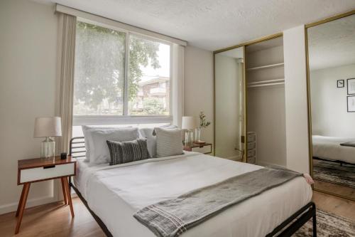 a bedroom with a large bed and a large window at Mountain View 1br w balcony pool nr shops SFO-1588 in Mountain View