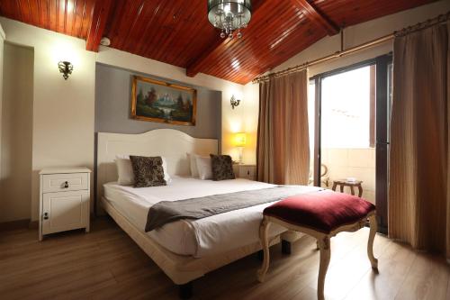 a bedroom with a large bed and a window at Asmali Hotel in Istanbul