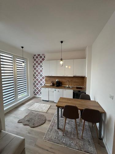 a kitchen with a table and chairs in a room at Vučko II in Bjelašnica
