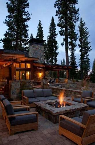 a patio with a fire pit in front of a house at Camp Beluan Ceria 