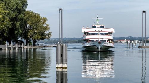 a boat in the water next to a dock at Villa Seeblick 1908 in Bregenz