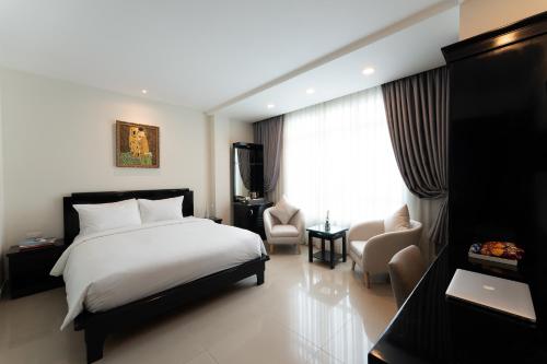 Säng eller sängar i ett rum på Saigon E Central Hotel