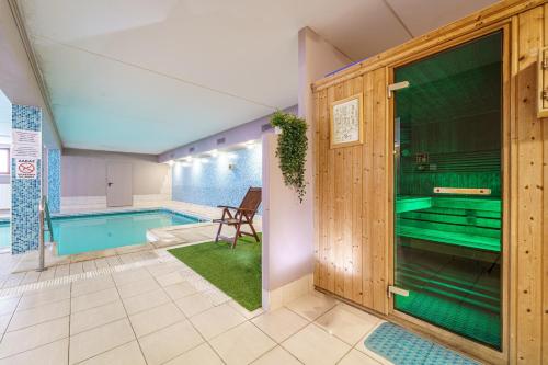 a swimming pool in a house with a room with a pool at Le Mont Medical & SPA in Świeradów-Zdrój