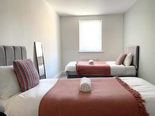 a room with two beds and a couch and a window at Cosy City Centre Townhouse in Elswick