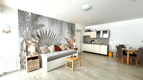 Apartmán Lamba Klínovec في لويكنا بود كلينوفسيم: غرفة معيشة مع أريكة وغرفة طعام