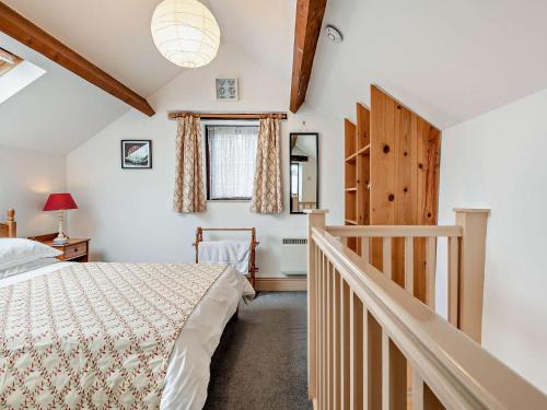 a bedroom with a bed and a stairway at 1 Bed in Wirksworth PK925 in Wirksworth