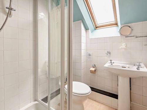 a bathroom with a shower and a toilet and a sink at 1 Bed in Wirksworth PK925 in Wirksworth