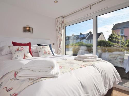 een slaapkamer met een wit bed en een groot raam bij 2 Bed in Westward Ho 45753 in Northam