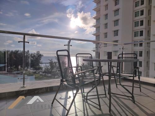 a balcony with chairs and a table on a building at Bay Resort by Evernent in Miri