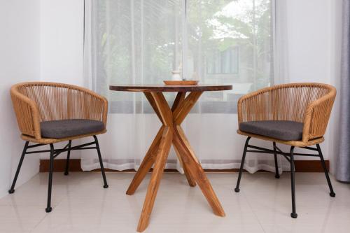 a wooden table with two chairs next to a window at Island's Pearl in Hinkong