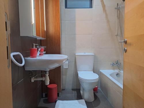 a small bathroom with a toilet and a sink at Door 51 in St Julian's