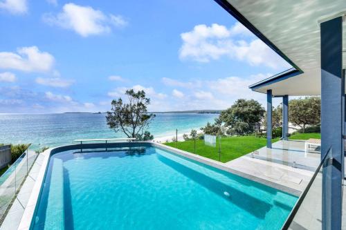 a swimming pool with a view of the ocean at Bellevue at Hyams, Hyams Beach in Hyams Beach