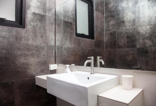 a bathroom with a white sink and a mirror at Island's Pearl in Hinkong