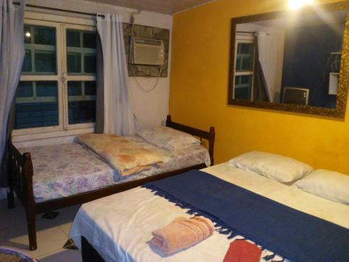 Ένα ή περισσότερα κρεβάτια σε δωμάτιο στο Pousada Center Lux