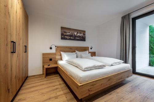 a bedroom with a bed and a large window at Waldnest in Kitzbühel