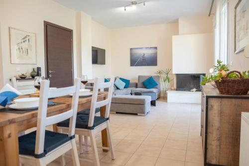 a kitchen and living room with a table and chairs at Solari Hill Maisonette two private parking in Corfu