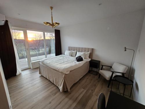 a bedroom with a bed with a cat laying on it at Luxury 3 Bedroom Modern House in Nature in Uddevalla