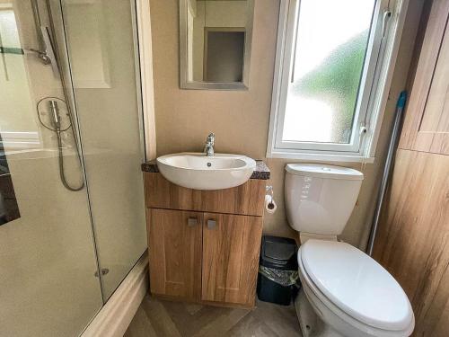 a bathroom with a toilet and a sink and a shower at Beautiful 6 Berth Caravan At Caldecott Hall Country Park, Norfolk Ref 91150c in Great Yarmouth